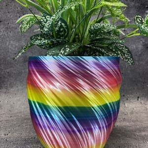 May include: A set of three ceramic mugs with a speckled, matte finish. The mugs are in shades of cream, light gray, and dark gray. Each mug has a simple, minimalist design, perfect for coffee or tea.