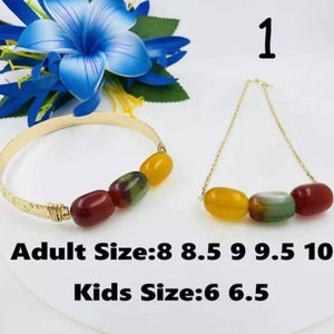 May include: A gold bracelet and necklace set with three colorful agate beads. The bracelet is 8, 8.5, 9, 9.5, or 10 inches. The necklace is 6 or 6.5 inches.  Adult Size: 8 8.5 9 9.5 10 Kids Size: 6 6.5