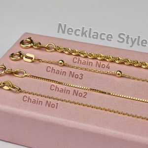 a pink box with four different types of chain necklaces