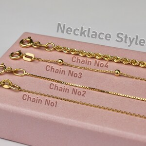 a pink box with four different types of chain necklaces