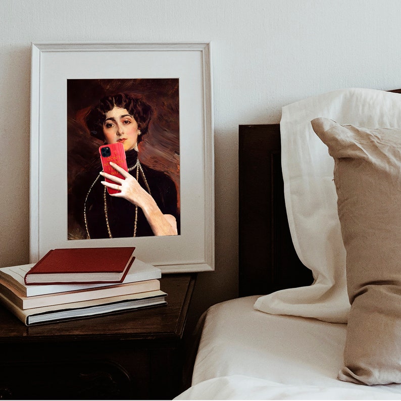 May include: A framed portrait of a woman in a black dress with a pearl necklace, holding a red smartphone in front of her face.