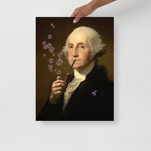 May include: A framed print featuring a portrait of George Washington with a pipe, exhaling bubbles. The artwork has a vintage aesthetic, with a dark background and a classic portrait style. The bubbles add a whimsical touch to the historical figure.