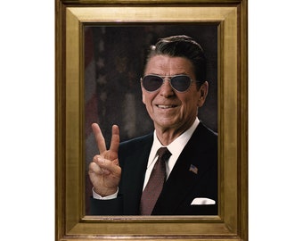 May include: A framed portrait of a man wearing sunglasses and a suit, giving a peace sign with his right hand.