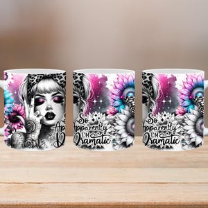 May include: White ceramic mug with a design featuring a woman with a leopard print headband and tattoos, and the text "So Apparently I'm Dramatic." The design includes pink, blue, and black floral elements.