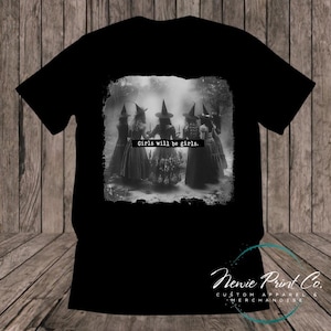 Witches in the forest design on custom t-shirt with the slogan “Girls Will Be Girls”. Feminist and empowering print on 100% cotton tee, perfect for girls and women, printed using high-quality DTF/DTG technology.