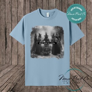 Witches in the forest design on custom t-shirt with the slogan “Girls Will Be Girls”. Feminist and empowering print on 100% cotton tee, perfect for girls and women, printed using high-quality DTF/DTG technology.