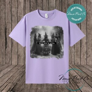 Witches in the forest design on custom t-shirt with the slogan “Girls Will Be Girls”. Feminist and empowering print on 100% cotton tee, perfect for girls and women, printed using high-quality DTF/DTG technology.