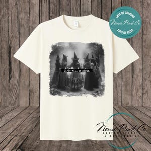 Witches in the forest design on custom t-shirt with the slogan “Girls Will Be Girls”. Feminist and empowering print on 100% cotton tee, perfect for girls and women, printed using high-quality DTF/DTG technology.