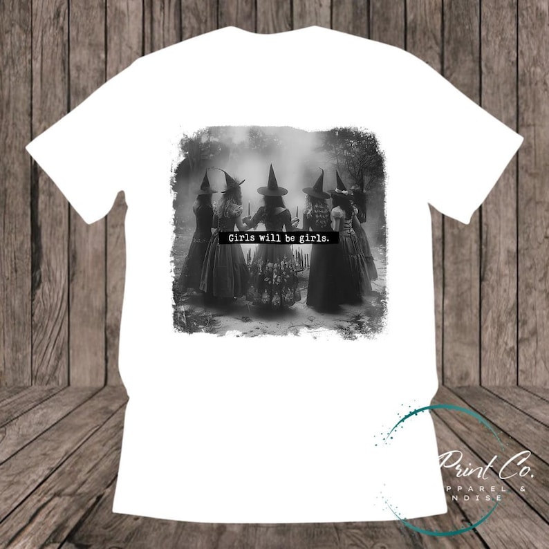 Witches in the forest design on custom t-shirt with the slogan “Girls Will Be Girls”. Feminist and empowering print on 100% cotton tee, perfect for girls and women, printed using high-quality DTF/DTG technology.