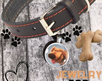 May include: Black leather dog collar with orange stitching and a silver buckle. A round pendant with a cartoon dog image hangs from the collar. The image also includes a dog bone and the text "JEWELRY FOR PETS."
