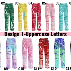 May include: Collection of pajama pants in various colors, each featuring a large initial letter and the name "Kinsley" repeated throughout. The pants come in shades like purple, green, yellow, red, pink, blue, and black.
