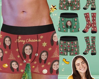 May include: Red boxer briefs with a Christmas theme featuring a repeating pattern of snowflakes, Christmas trees, ornaments, and faces. The text "Merry Christmas" is printed in gold on the front of the underwear.