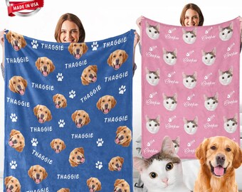 May include: Two fleece blankets, one blue and one pink, are displayed. The blue blanket features golden retriever faces, paw prints, and the word "THAGGIE." The pink blanket has cat faces, fish bones, and the word "Coopie."