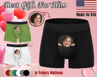 May include: Six pairs of underwear in different colors, including green, white, black, red, blue, and gray. Each pair has a small pocket on the front with a person's face peeking out. The text "Best Gift For Him" and "Made In USA" are visible in the image.