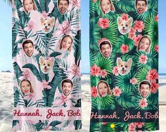 May include: Two personalized beach towels with tropical floral and face designs. One towel has a pink background, the other is green. Each towel features faces, a dog, and the names "Hannah, Jack, Bob". The towels are hanging on a clothesline.