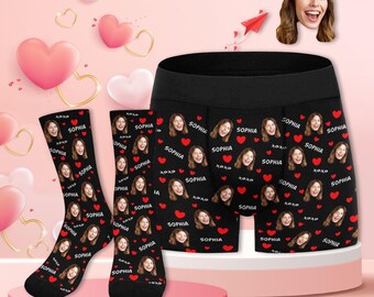 May include: A set of black underwear and socks with a repeated pattern of a woman's face and the word "Sophia" in white text. Red hearts are interspersed throughout the pattern.
