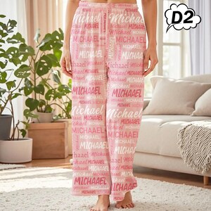 May include: Pink pajama pants with the name "Michael" printed repeatedly in white. The pants have a relaxed fit and a drawstring waistband. The pajama pants are made of a soft, lightweight fabric.
