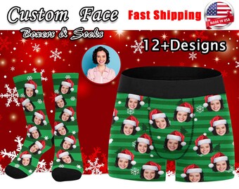 May include: A pair of green and white Christmas-themed socks with a person's face printed on them. The socks have a Santa hat design and snowflakes. The image also shows a pair of green and white boxer shorts with a person's face printed on them. The boxer shorts have a Santa hat design and snowflakes.