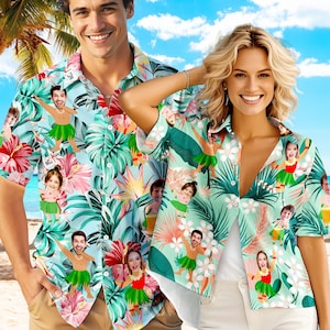 May include: Two short-sleeved Hawaiian shirts with a tropical floral and hula dancer design. The shirts feature a light blue and mint green background with a repeating pattern of flowers, leaves, and cartoon hula dancers. The shirts are button-down and have a relaxed fit.