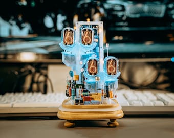 May include: A clock made of clear plastic with four Nixie tubes displaying the numbers 6, 6, 6, and 6. The clock is on a wooden base with a gold finish.