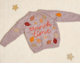 Crunch time themed knitted cardigan with crochet/embroidered details