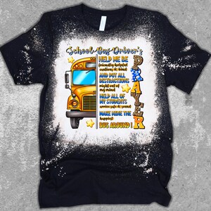 May include: Black t-shirt with a distressed white design. The shirt features a yellow school bus graphic and text that reads "School Bus Driver's Prayer". The prayer includes phrases like "Help me be friendly" and "Make mine the happiest bus around!"