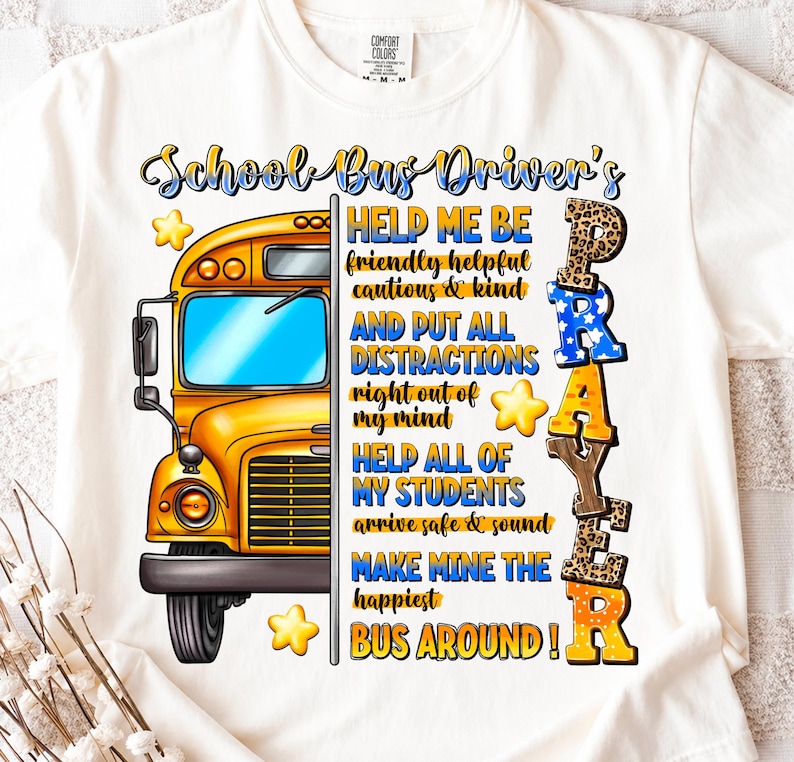 May include: White t-shirt featuring a yellow school bus graphic with the text "School Bus Driver's Prayer." The design includes the words "Help Me Be," "Help All of My Students," and "Make Mine the Happiest Bus Around!"