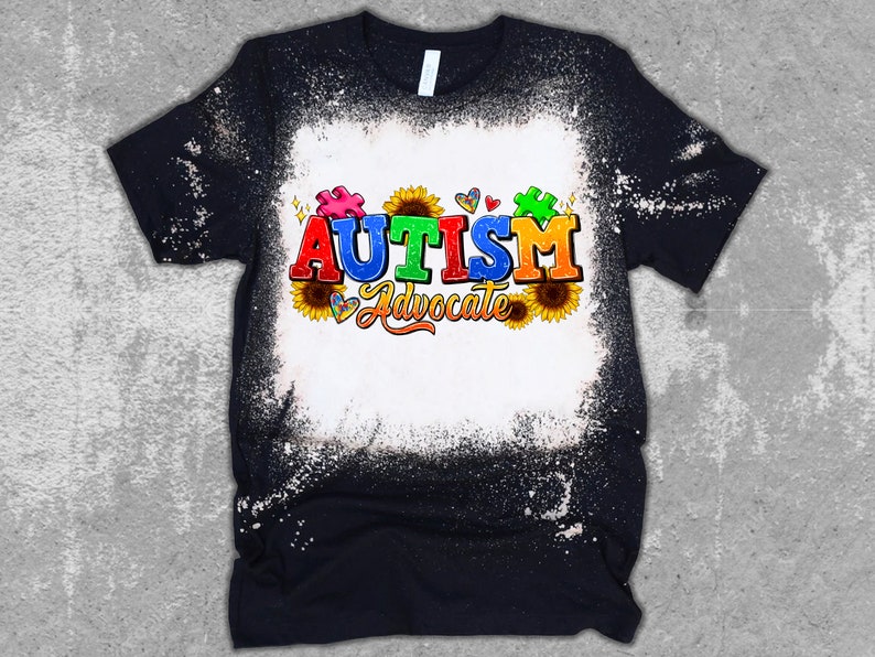 May include: A black t-shirt with a white bleach design. The design features the word "AUTISM" in colorful letters, a puzzle piece, sunflowers, and the words "Advocate".