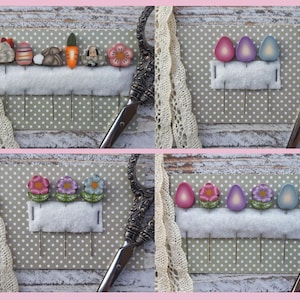 May include: A set of six Easter-themed pins featuring various designs, including a chick, an egg, a bunny, a carrot, a flower, and a lamb. The pins are displayed on a grey background with white polka dots.