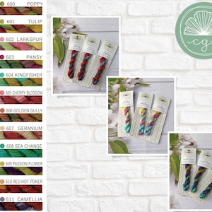 May include: A collection of variegated embroidery floss skeins displayed on branded paper cards. The image features a color chart listing numbers 600 through 611 with corresponding names like Poppy, Tulip, and Camellia, alongside photos of the thread.