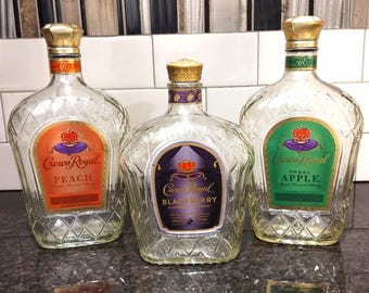 Empty Crown Royal Apple, Blackberry, and Peach bottles, 1 L size, rinsed with lids included