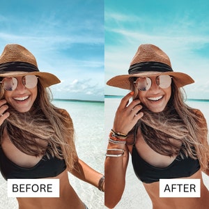 May include: A woman wearing a brown straw hat with a black band, sunglasses, and a black bikini top smiles at the camera while standing in shallow water. The water is a bright turquoise color and the sky is blue with white clouds.
