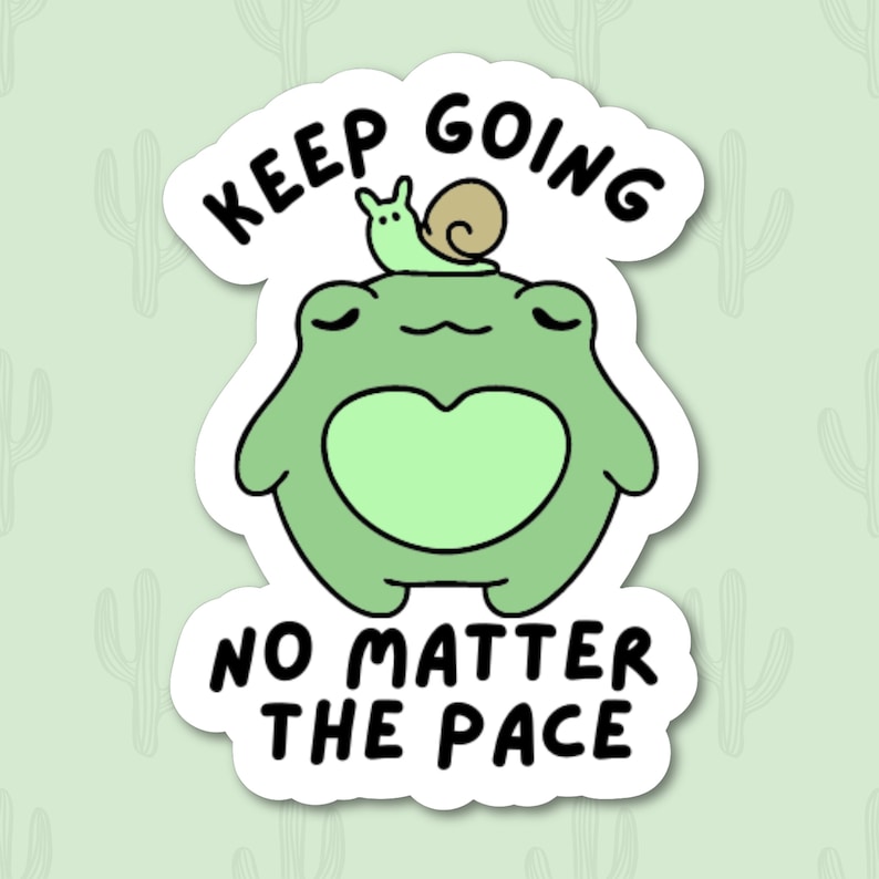 May include: Green frog sticker with a green snail on its head. The sticker says "Keep Going No Matter The Pace".