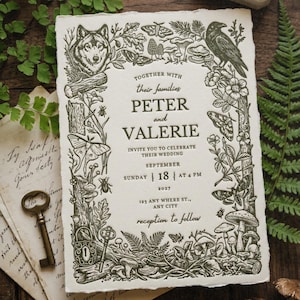 May include: Wedding invitation with a detailed forest-themed border featuring a wolf, raven, mushrooms, and butterflies. The invitation text reads "Peter and Valerie" with the date and time of the wedding. The invitation is on textured paper.