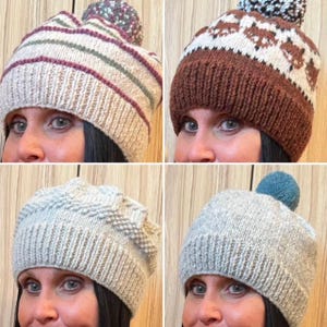 May include: Four knitted winter hats. One hat is beige with burgundy and green stripes and a multicolored pom-pom. Another is brown with a white geometric pattern. The third is light gray with a textured pattern. The last is light gray with a teal pom-pom.