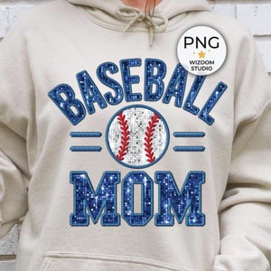May include: A beige hoodie with a blue and white baseball graphic and the text "Baseball Mom".
