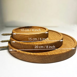 May include: Three wooden round coasters in different sizes. The smallest coaster is 4 inches in diameter, the middle coaster is 6 inches in diameter, and the largest coaster is 8 inches in diameter.