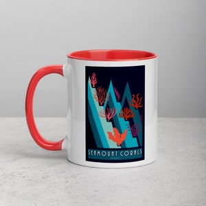 May include: White ceramic mug with a red rim and handle. The mug features a graphic of stylized coral reefs in shades of blue, pink, and red against a dark blue background. The text "Seamount Corals" is printed in white at the bottom of the graphic.