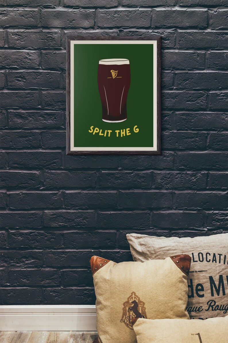May include: A framed print with a green background and a cartoon illustration of a pint of Guinness. The text "SPLIT THE G" is printed in yellow below the pint.