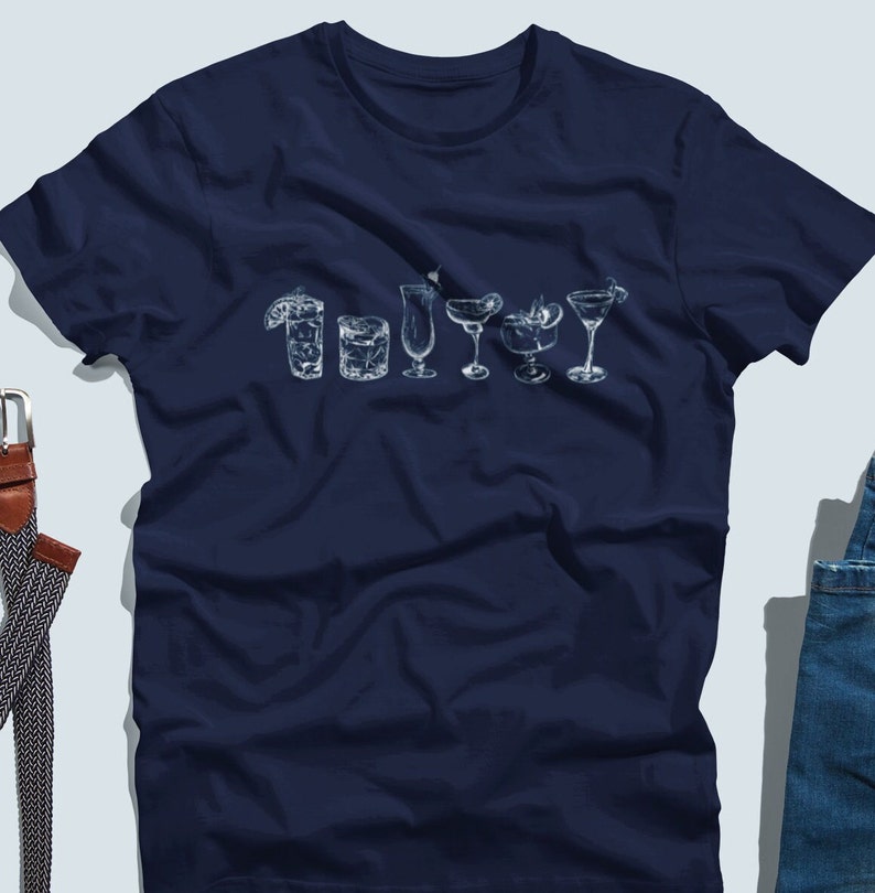 May include: A navy blue t-shirt with a white graphic of different types of cocktails. The graphic includes a margarita, a martini, a daiquiri, a collins, a highball, and a whiskey sour.