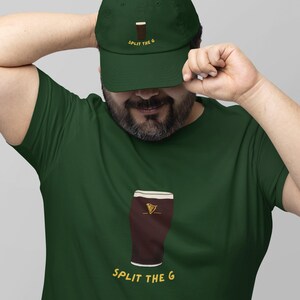 May include: A green t-shirt with a cartoon illustration of a pint of beer and the text "SPLIT THE G". The person is wearing a green baseball cap with the text "SPLIT THE G" and a cartoon illustration of a pint of beer.