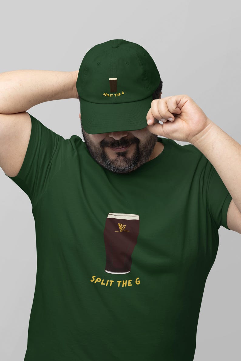 May include: A green t-shirt with a cartoon illustration of a pint of beer and the text "SPLIT THE G". The person is wearing a green baseball cap with the text "SPLIT THE G" and a cartoon illustration of a pint of beer.