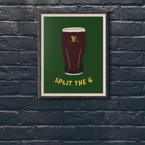 May include: A framed print with a green background featuring a cartoon illustration of a glass of dark beer with the text "SPLIT THE G" in yellow.