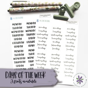 May include: Two sheets of white paper with black text that reads "Days of the Week" and lists the days of the week in two different fonts. The text is repeated multiple times on each sheet. The sheets are held together with two green binder clips.