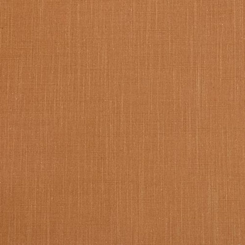 May include: A close-up of a brown fabric with a subtle woven texture. The fabric has a warm, earthy tone.