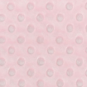 May include: Pink fabric with a textured pattern of small white circles.