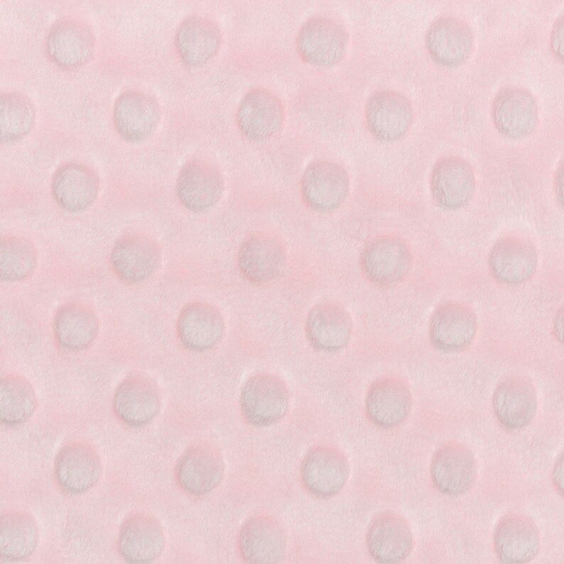 May include: Pink fabric with a textured pattern of small white circles.
