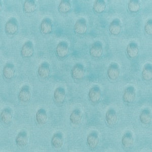 May include: A close-up of a light blue fabric with a textured pattern of small raised circles.
