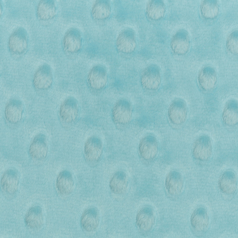 May include: A close-up of a light blue fabric with a textured pattern of small raised circles.