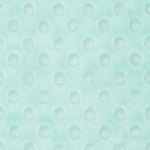 May include: A close-up of a light blue fabric with a textured pattern of small, raised circles.